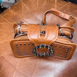 Chic Brown Leather Wristlet with Decorative Accents